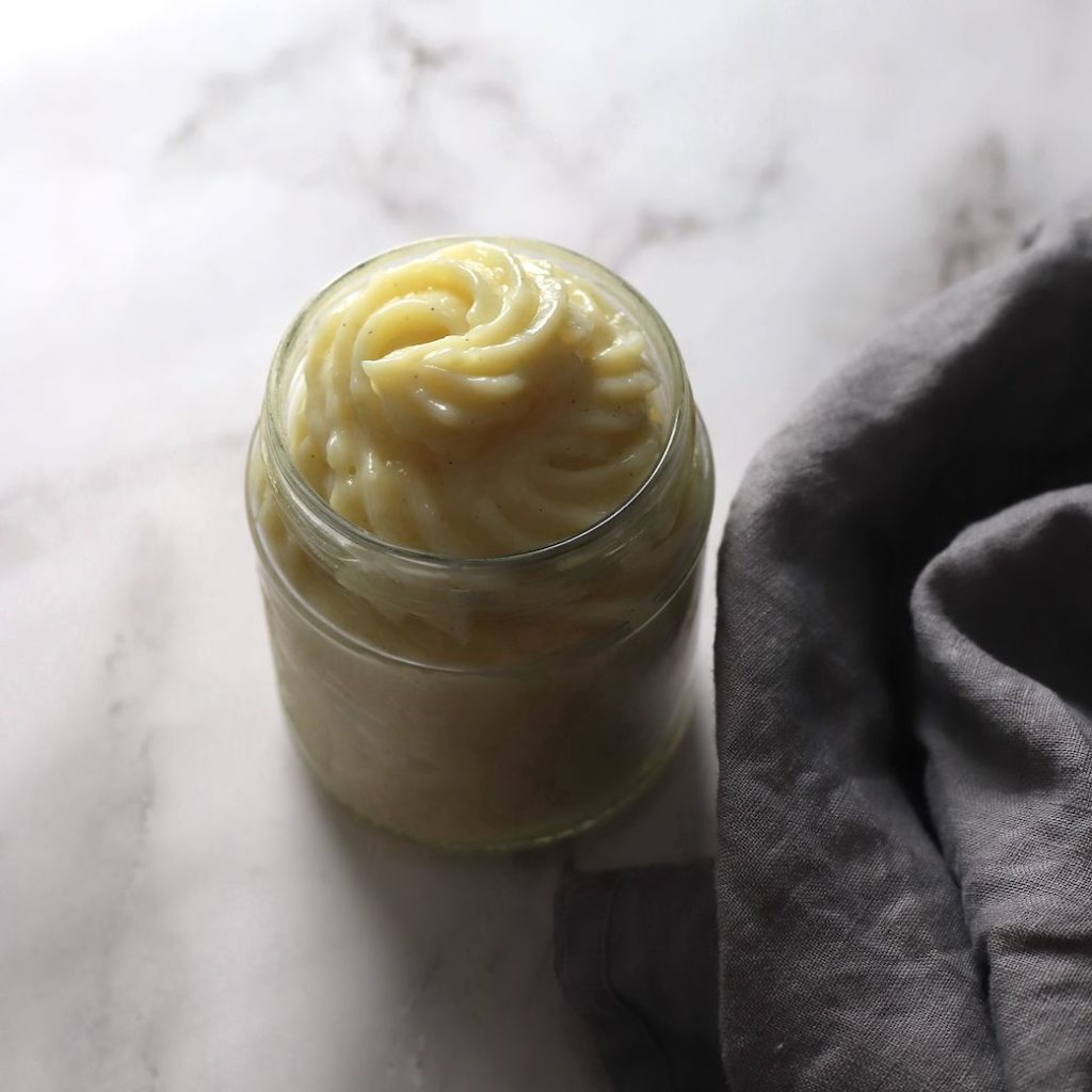A jar full of piped creme patisserie.