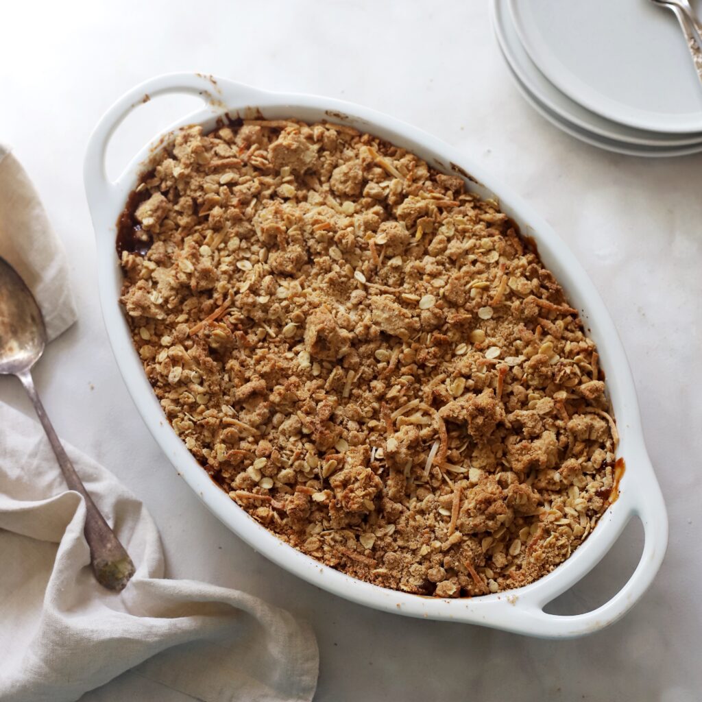 Top down image of Apple Crumble served in an oval dish.