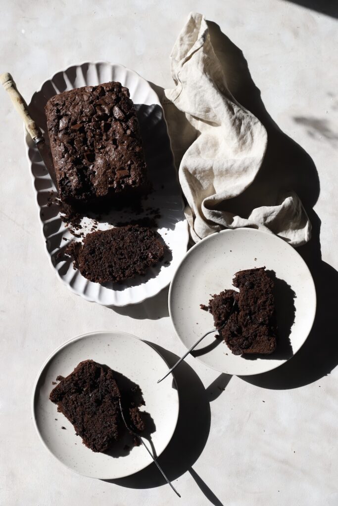 The sliced loaf with a piece in each of the two side plates.