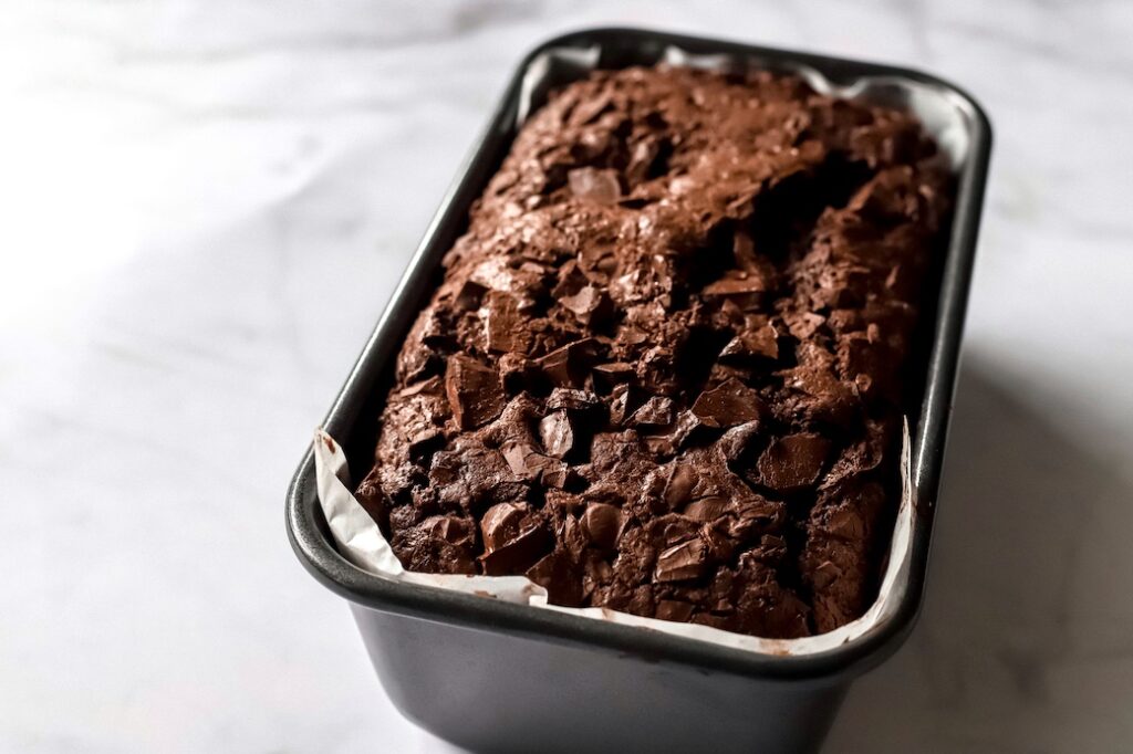 A freshly baked Double Chocolate Zucchini Loaf in its tin.