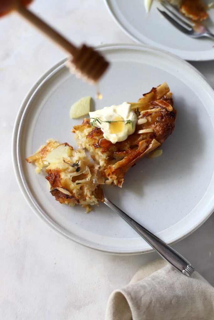 Honey drizzling on to a slice of the pear and Camembert tart.